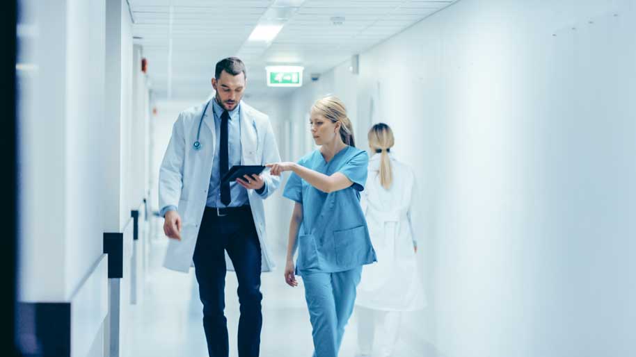 Doctor and nurse reviewing online waiver form